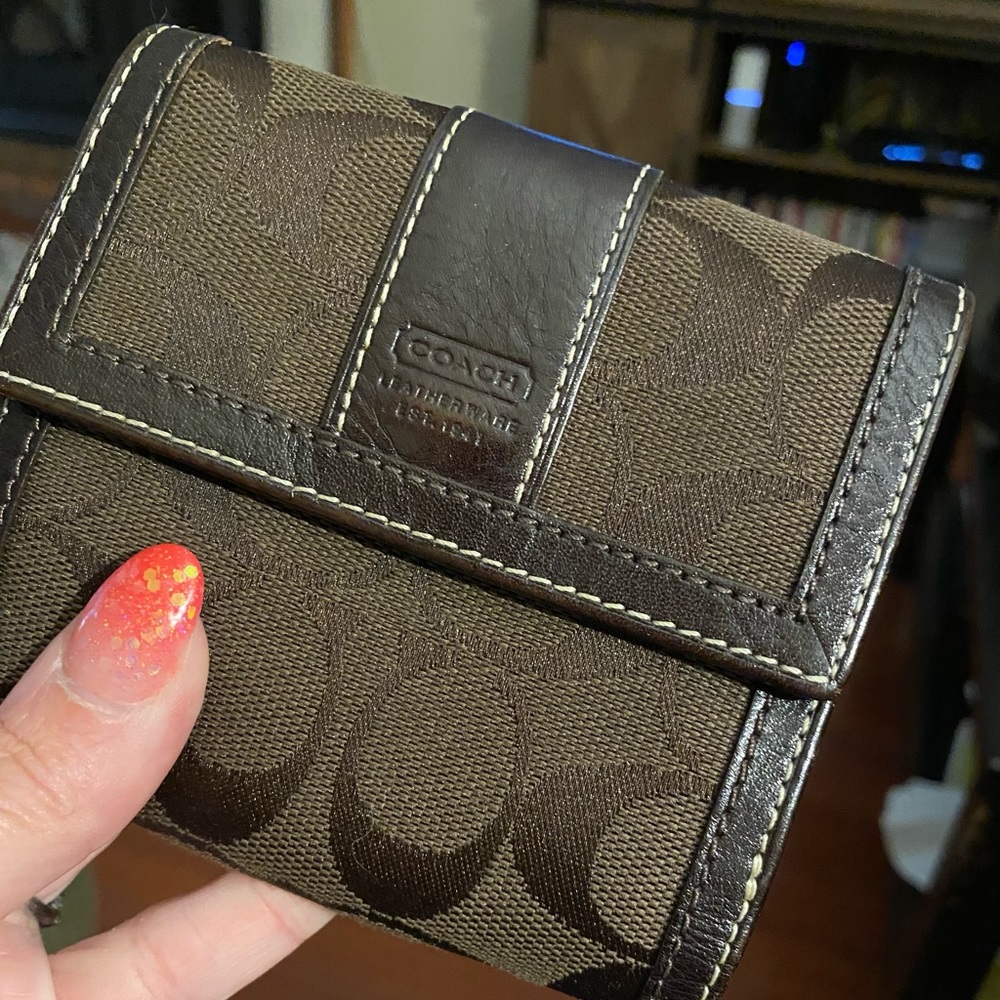 Dark brown signature Coach women’s wallet :)